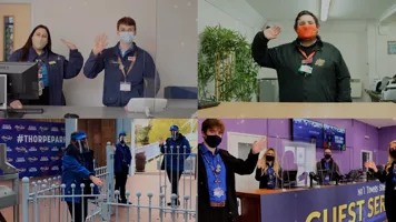 Staff Members Waving at Merlin Attractions